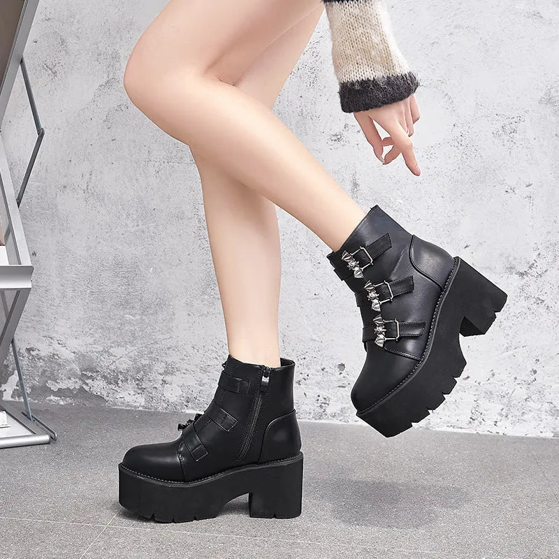 Black women's gothic punk Martin boots with a silver bat buckle and side zip.