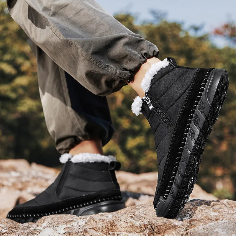 Men's plus size snow boot in a solid colour with a round toe, flat heel, and non-slip rubber sole.