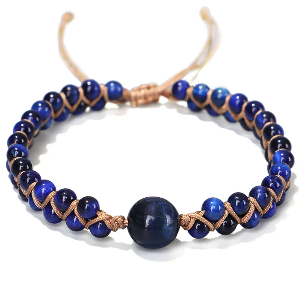 Hand-woven geometric pull bracelet made from blue tigereye stone beads on a wrist.