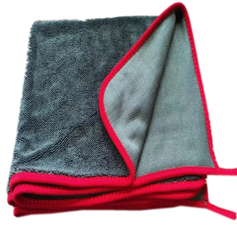 Grey car cleaning towel with black edge trim showing hemmed sides and spiral hair texture.
