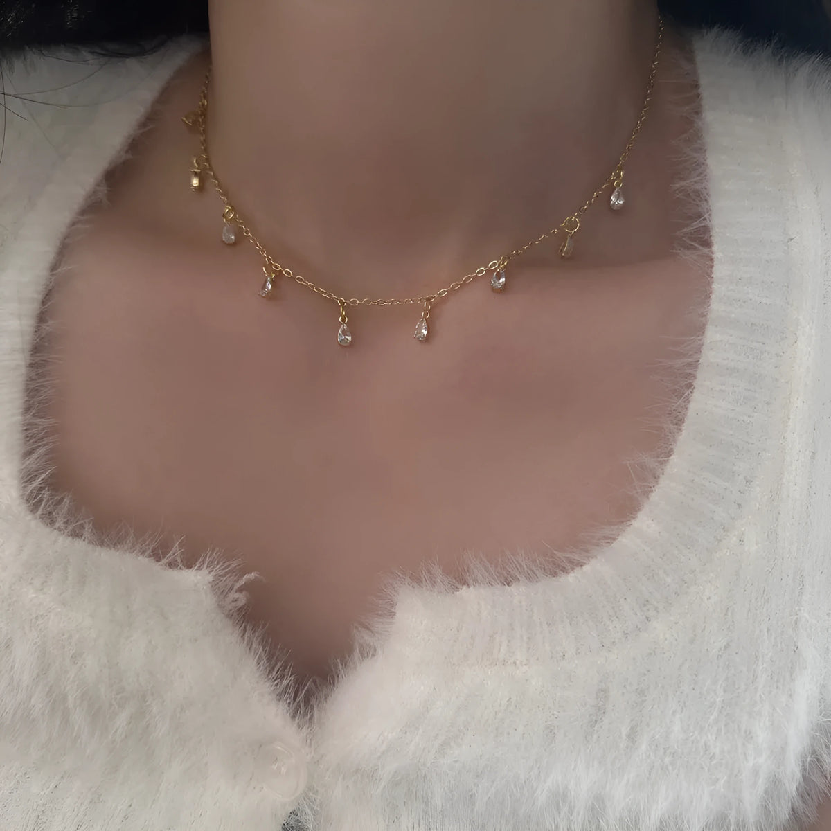 Women's zircon jewellery set showing geometric pendant necklace, matching earrings and coordinating anklet