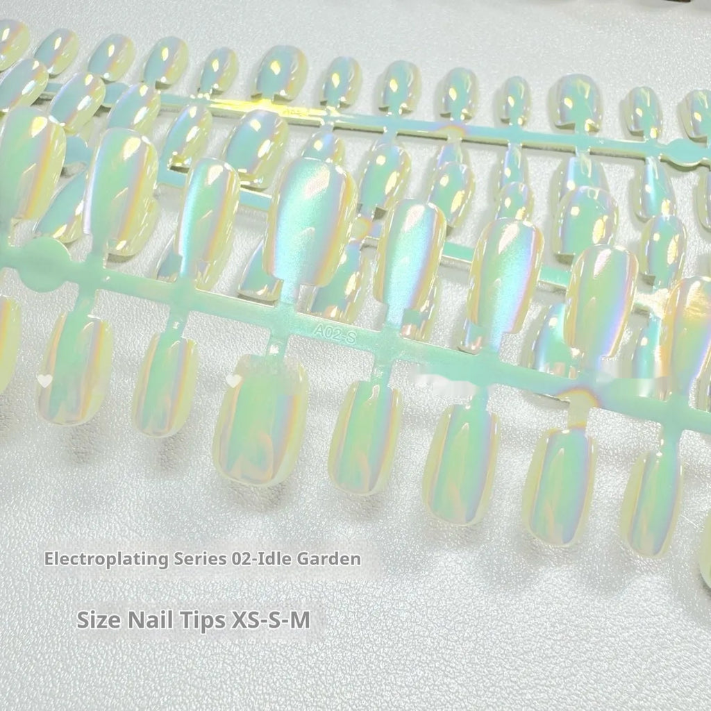 Electroplated Cat's Eye false nails showing Aurora light effect on short ladder shaped nails in XS, S, M sizes.