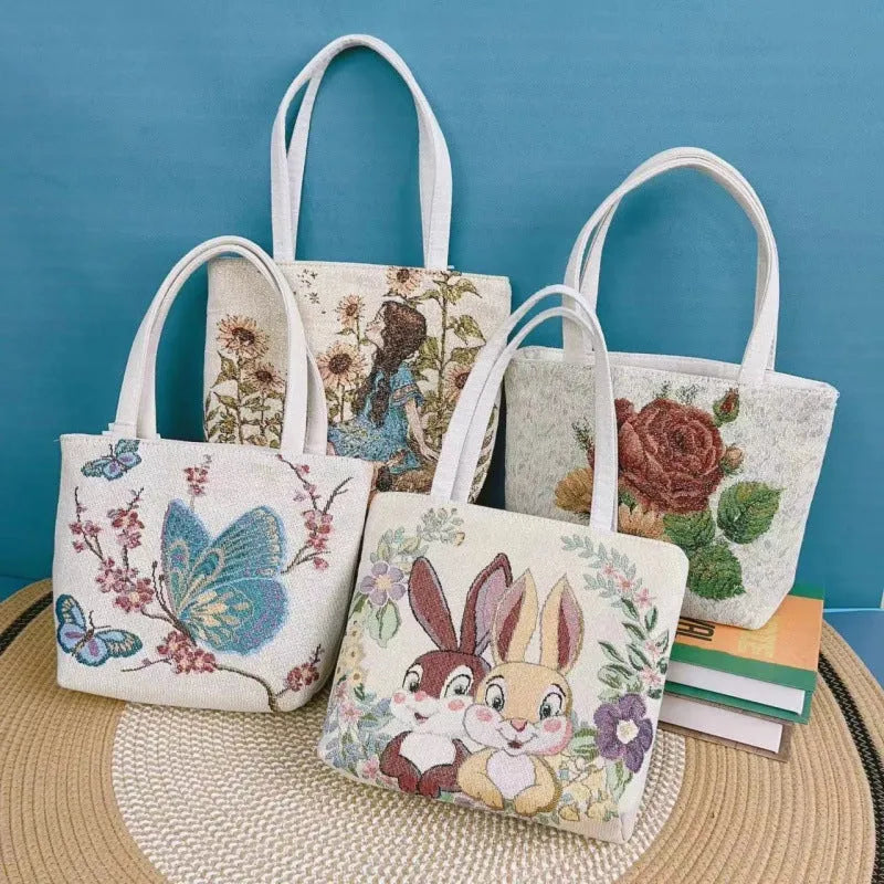 Gold wire embroidered canvas tote bag in choice of seven designs and three sizes.