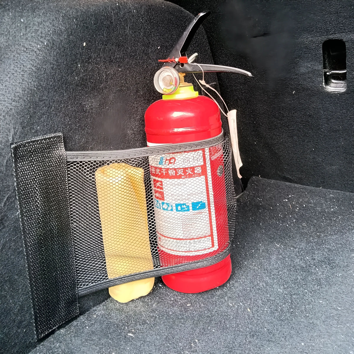 Elastic polyester mesh car boot storage organiser net shown in a vehicle trunk.