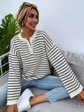 Black striped women's knitted top with drop shoulder sleeves on hanger