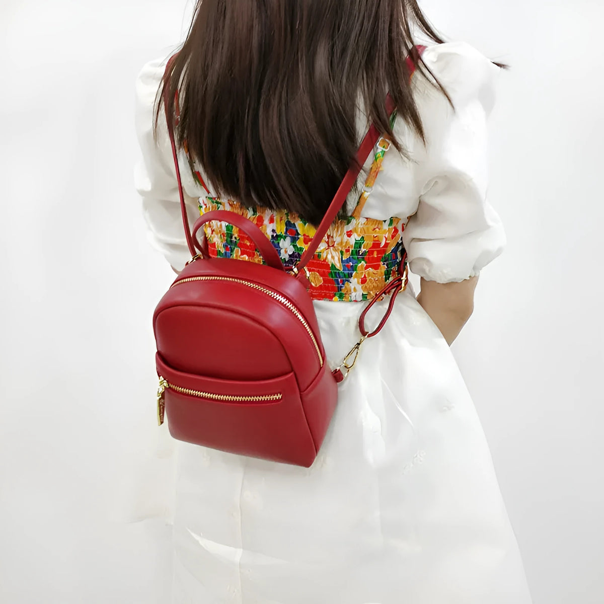 Soft PU mini backpack with three-dimensional pockets in six colour options including black, blue, pink, red, white, and yellow