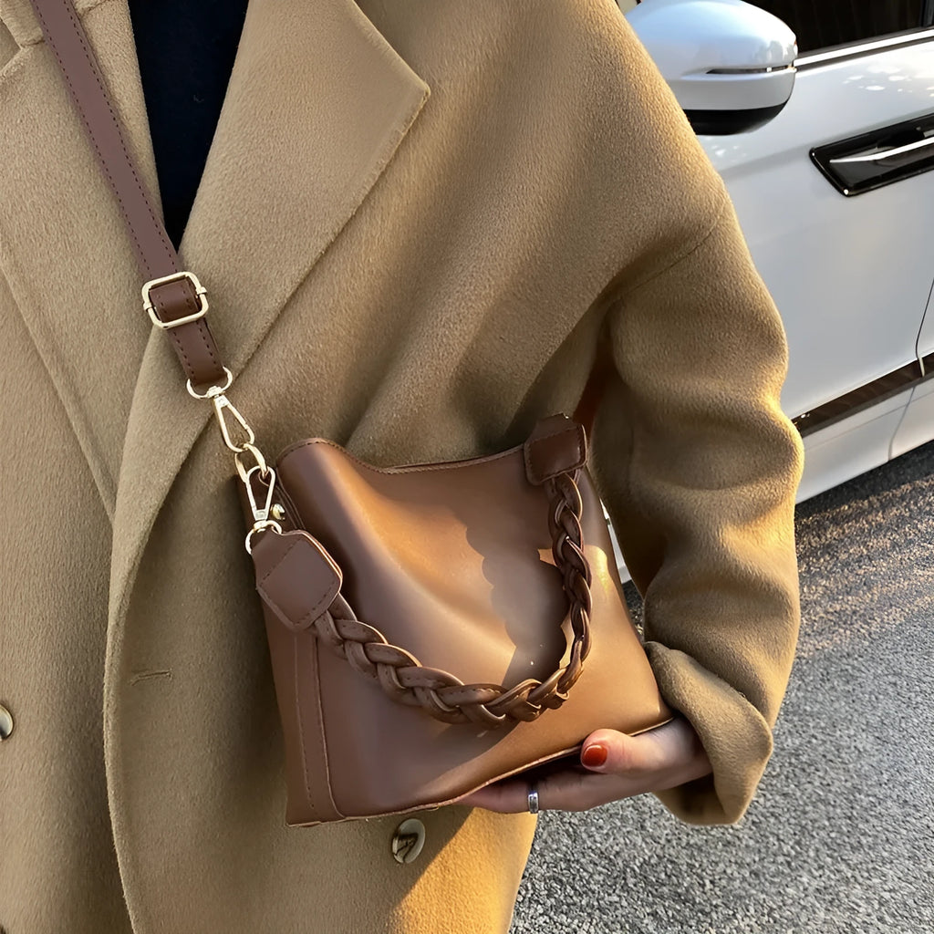 Retro woven crossbody bucket bag in khaki colour showing one-shoulder strap and textured PU material.