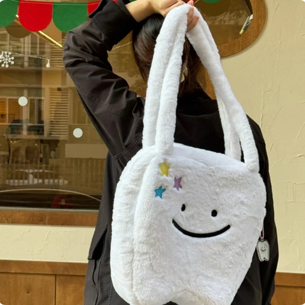 White plush shoulder tote bag with large tooth design and cute teeth pattern, showing zipper closure