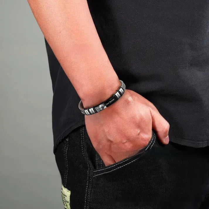 Men's stainless steel lettering bracelet with heart-shaped engraved beads on an adjustable brown leather rope strap.