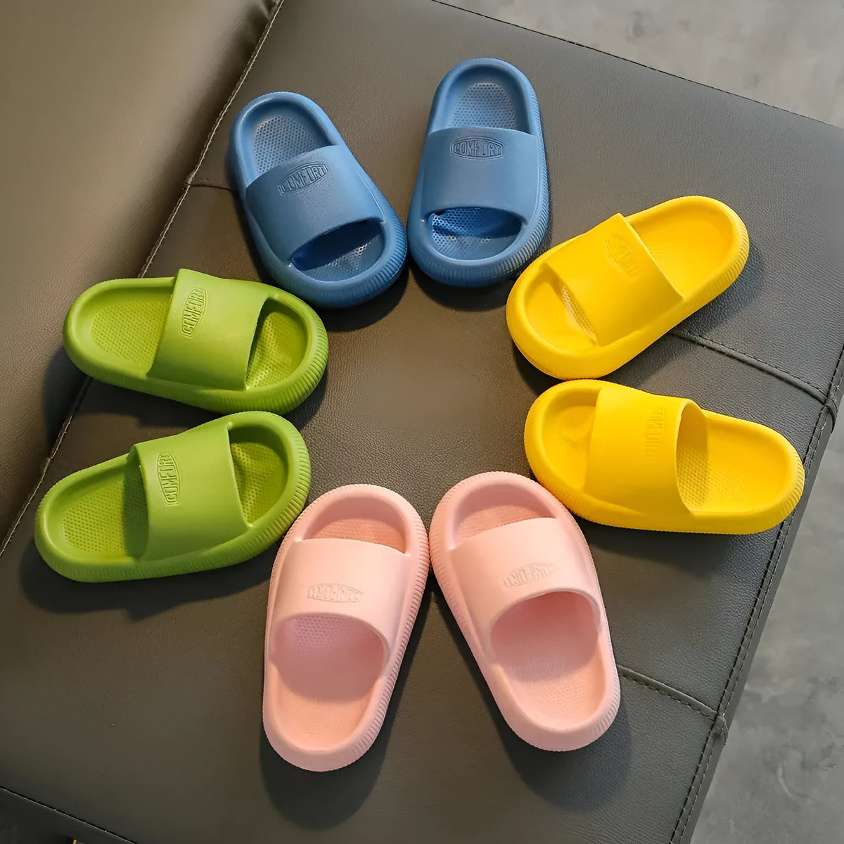 Children's EVA slippers in mixed colours with a textured non-slip sole, shown in sizes for kids.