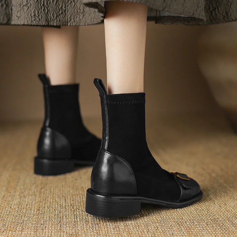 Black women's low heel Martin boots with belt buckle stitching and round toe.