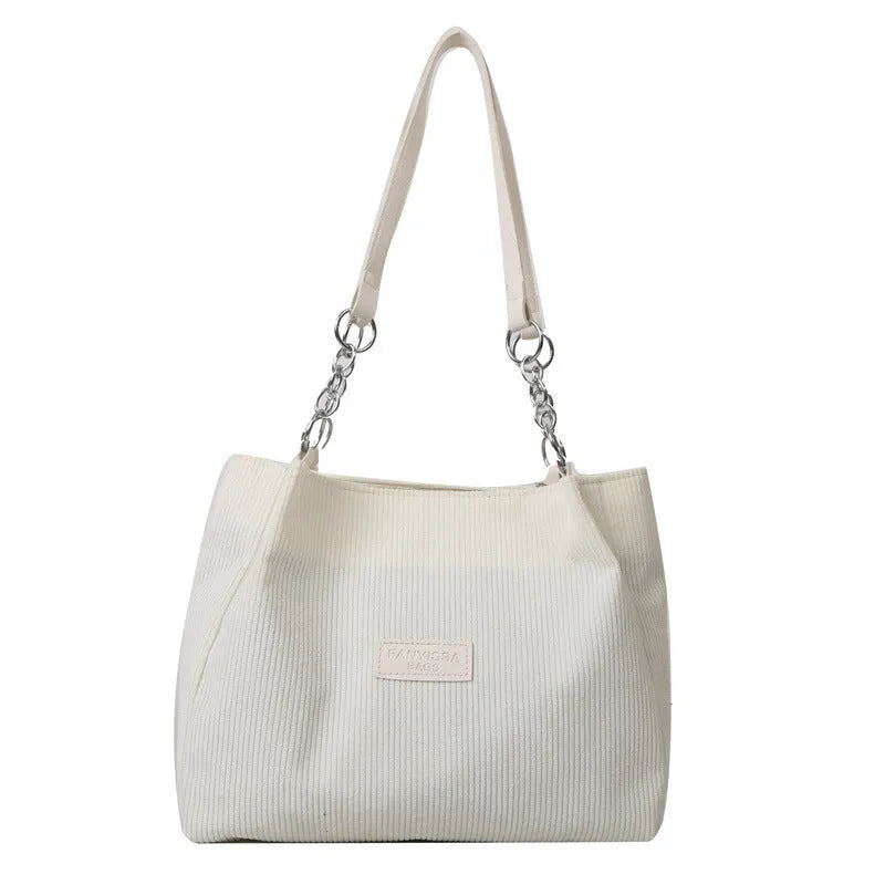 Corduroy one-shoulder tote handbag with three-dimensional pockets in black colour