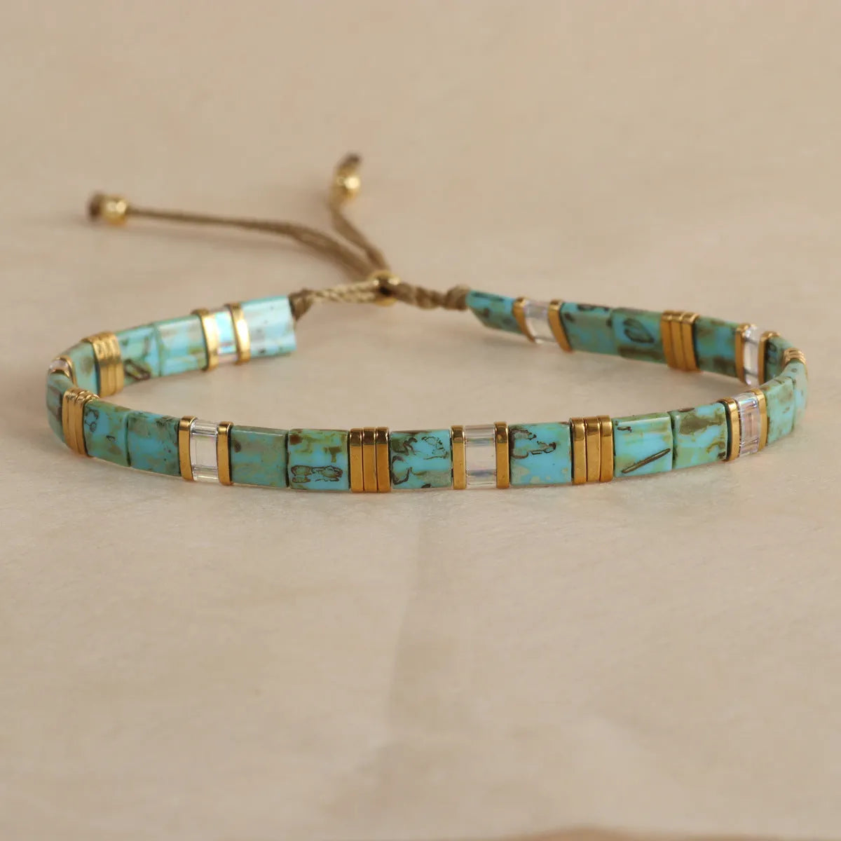 Glass bead geometric bracelet with round beads in five colour variations on wrist