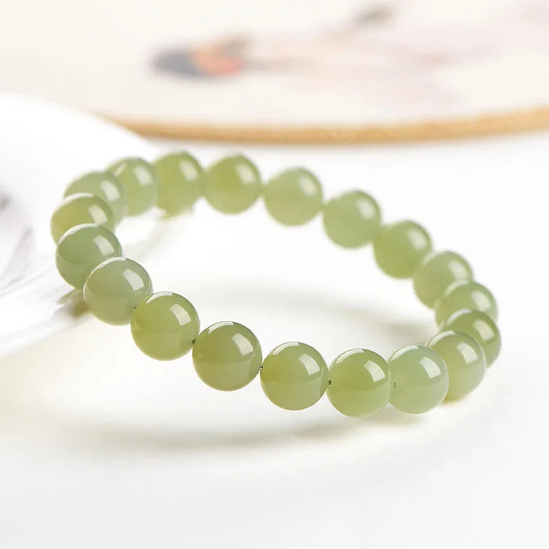 Polished Hetian jade ball bracelet showing spherical beads on a string.