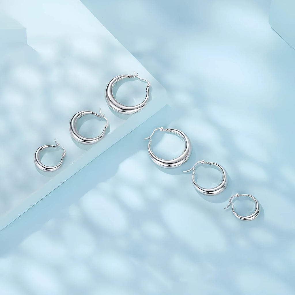 Copper geometric ring ear clip earrings showing large, medium, and small size options with silver needle fastenings
