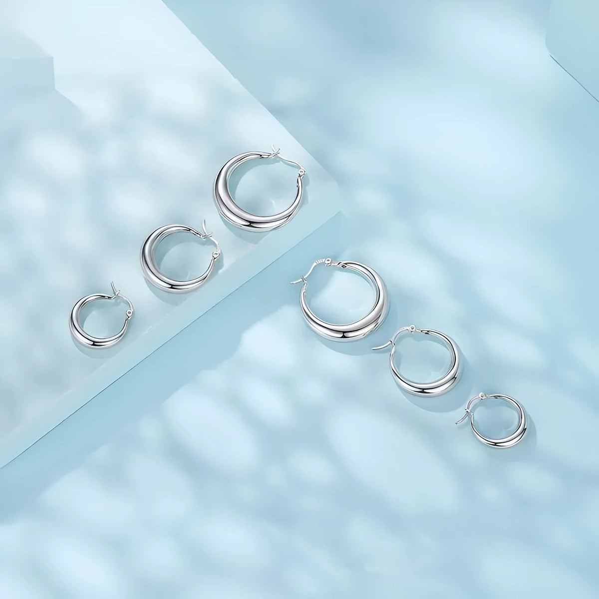 Copper geometric ring ear clip earrings showing large, medium, and small size options with silver needle fastenings