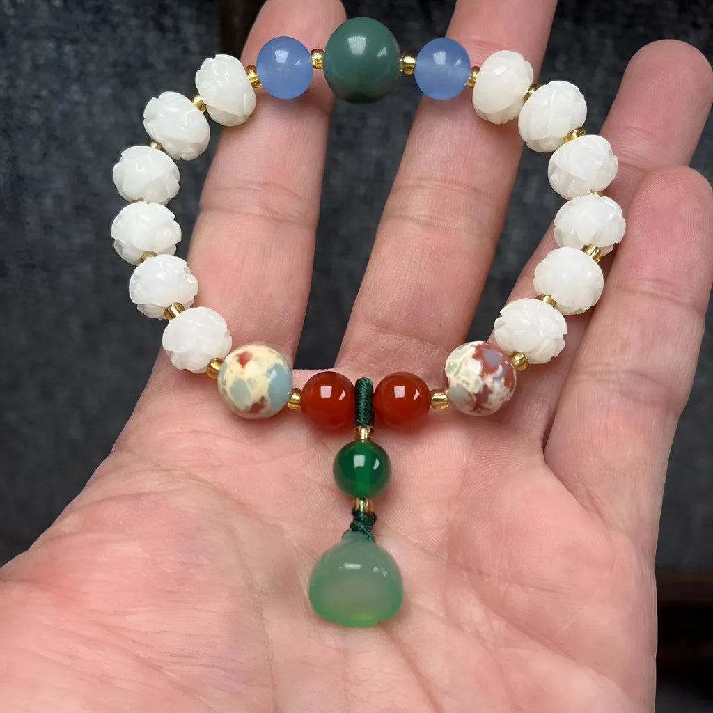Carved bodhi root bracelet with pumpkin lotus beads and white jade lotus detailing in multiple bead sizes