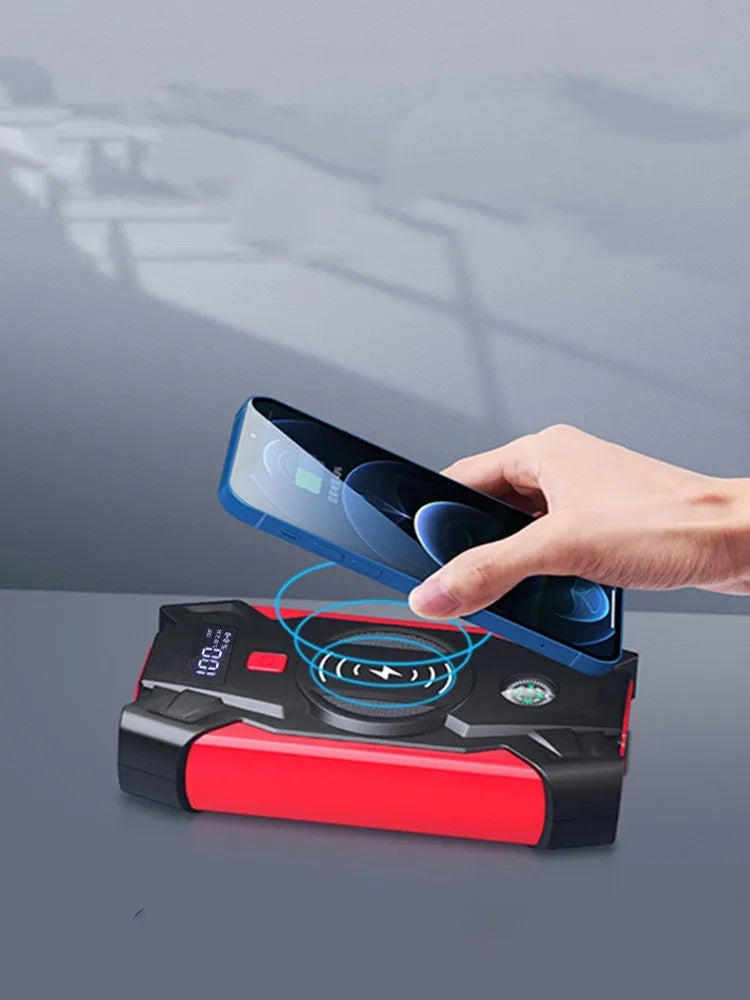 Red portable car jump starter unit with booster clamps and charger in storage box