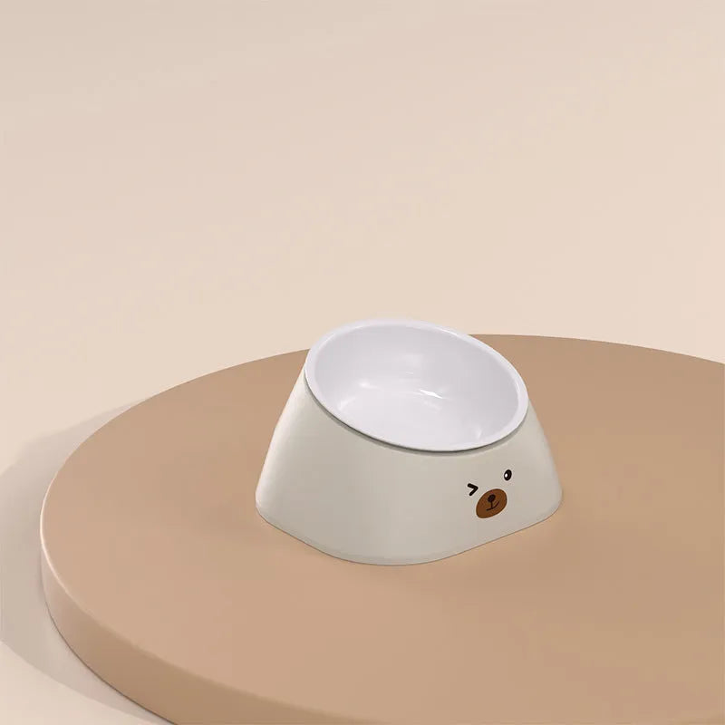 Green tilted stainless steel cat bowl with 15 degree angle on white PP plastic base