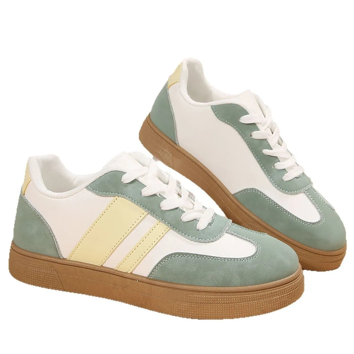 Green women's retro sports pumps with white cross straps and a round toe.
