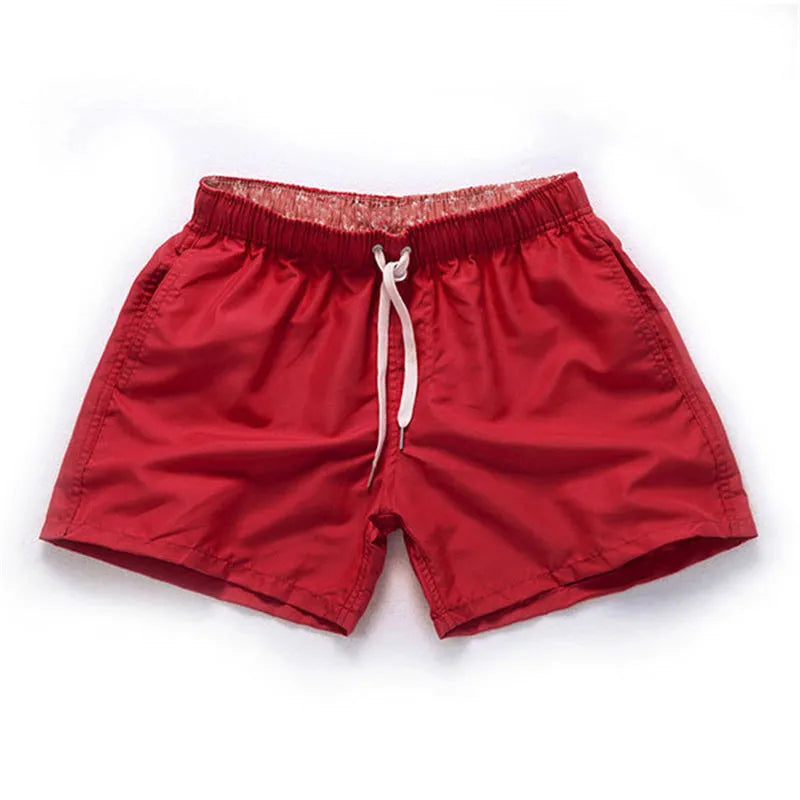 Men's polyester beach shorts in black with straight leg opening and grinded fabric texture available in sizes S to 4XL