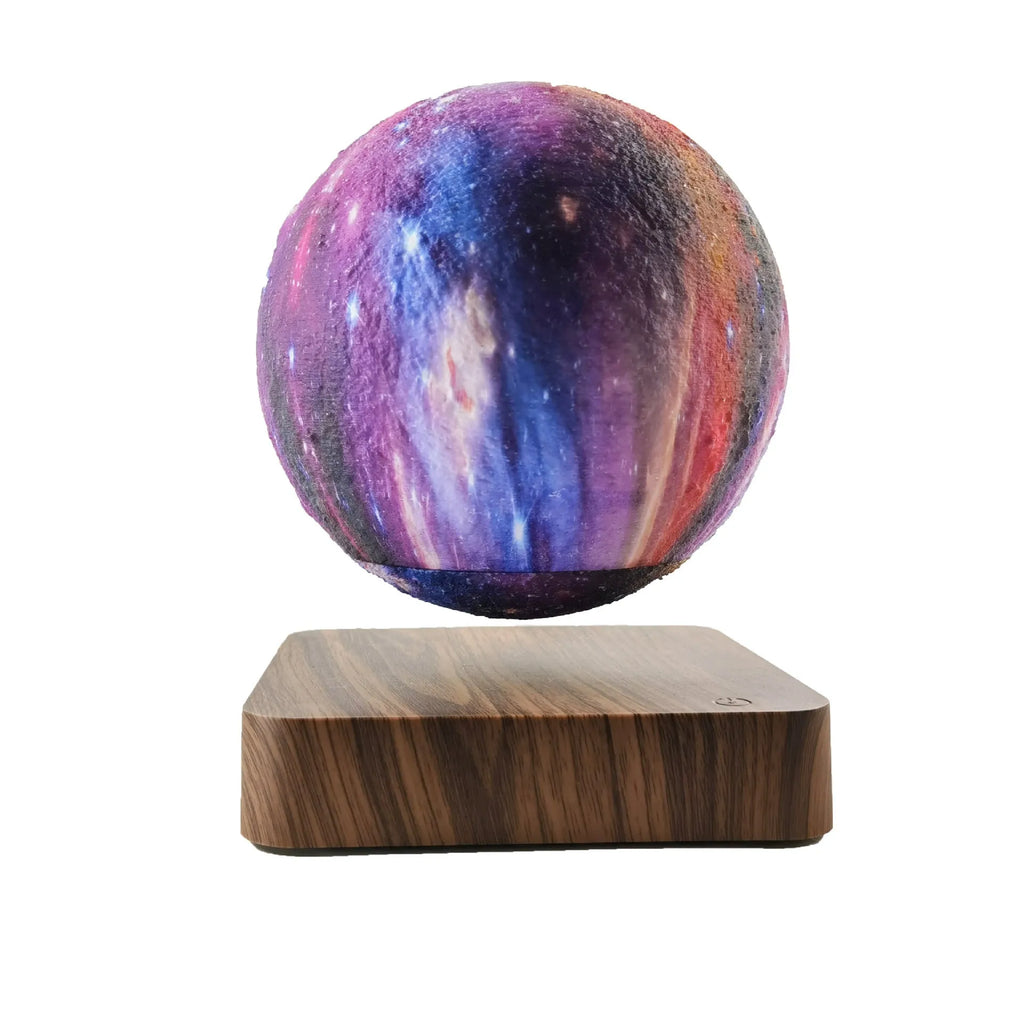 Square walnut coloured base with a levitating, glowing galaxy-patterned moon lamp above it
