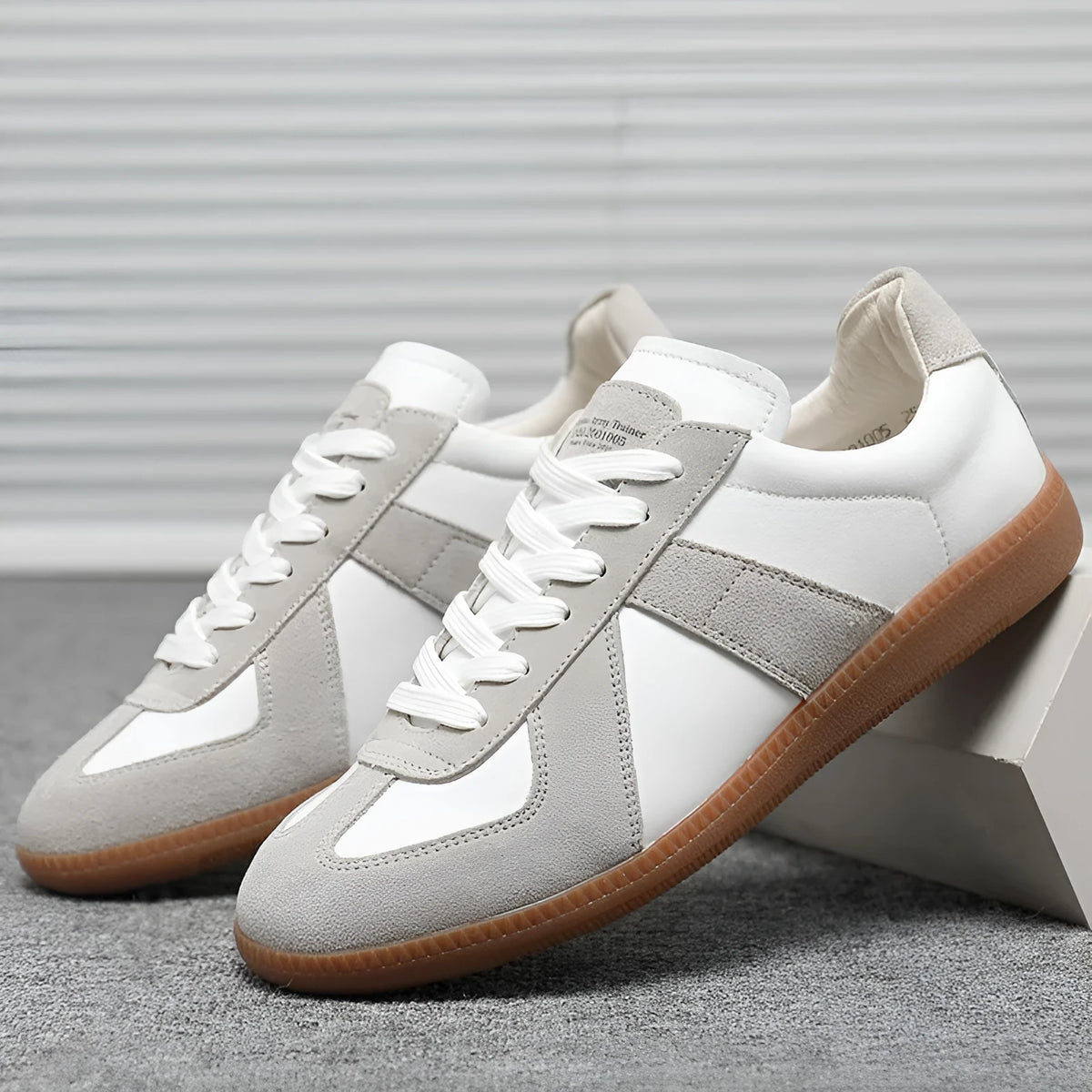 White Japanese-style retro low-top sneakers with round toe and lace-up front on a rubber sole.