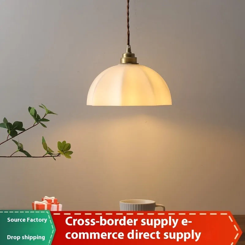 Brass Chinese style pendant light with copper glass shade hanging from ceiling
