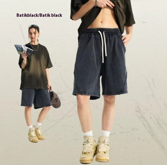 Men's loose-fit cotton terry shorts in batik colours on a size chart background.