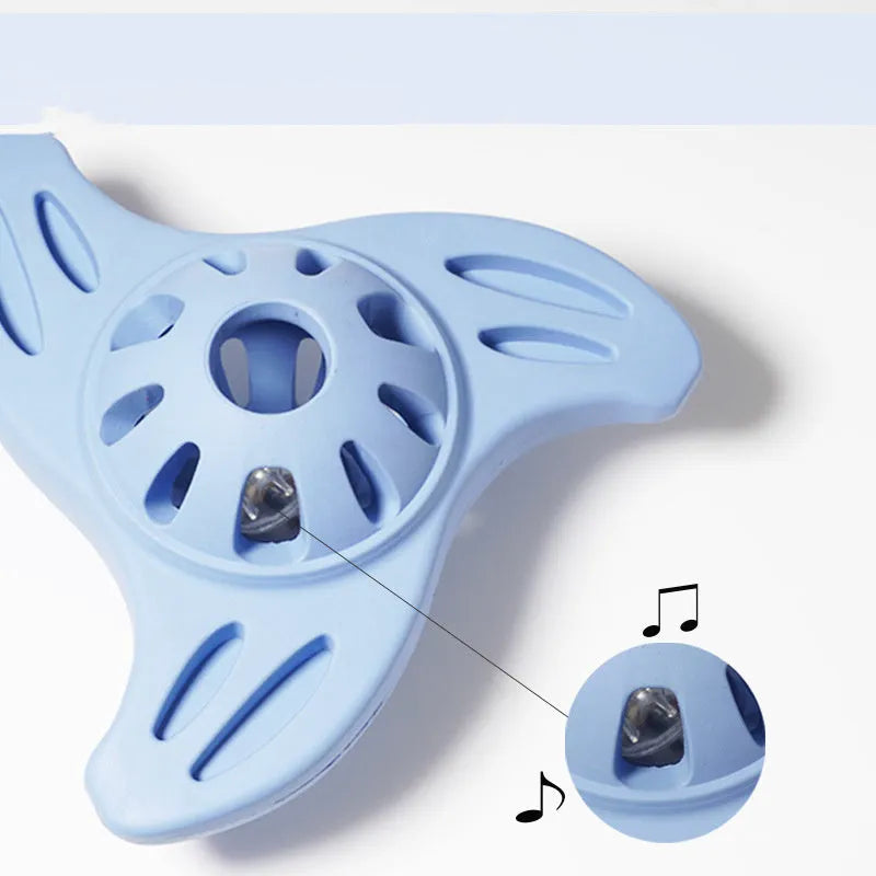 Blue boomerang-shaped natural rubber dog chew toy with raised ridges on a white background.
