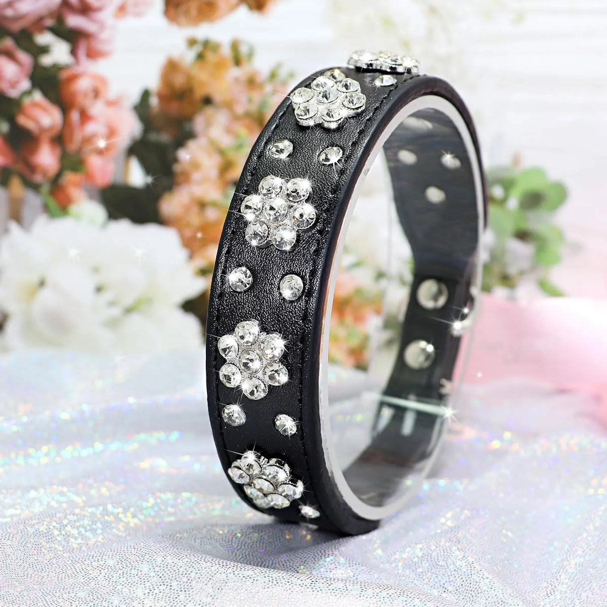 Black PU leather dog collar with diamond flower studs and a metal adjustable buckle.