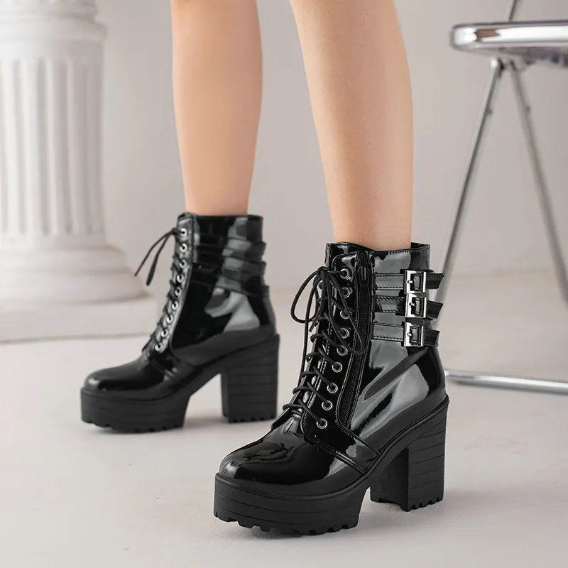 Women's black thick-heeled short boots with lace-up front and waterproof platform on a rubber sole.
