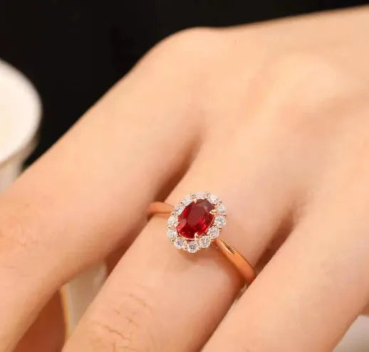 Women's silver-plated floral ring with a gold pigeon red blood gemstone centrepiece.