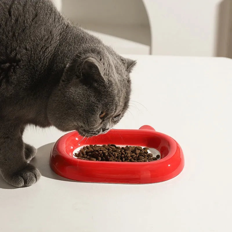 Ceramic animal-shaped pet bowl with cat design on stable flat base