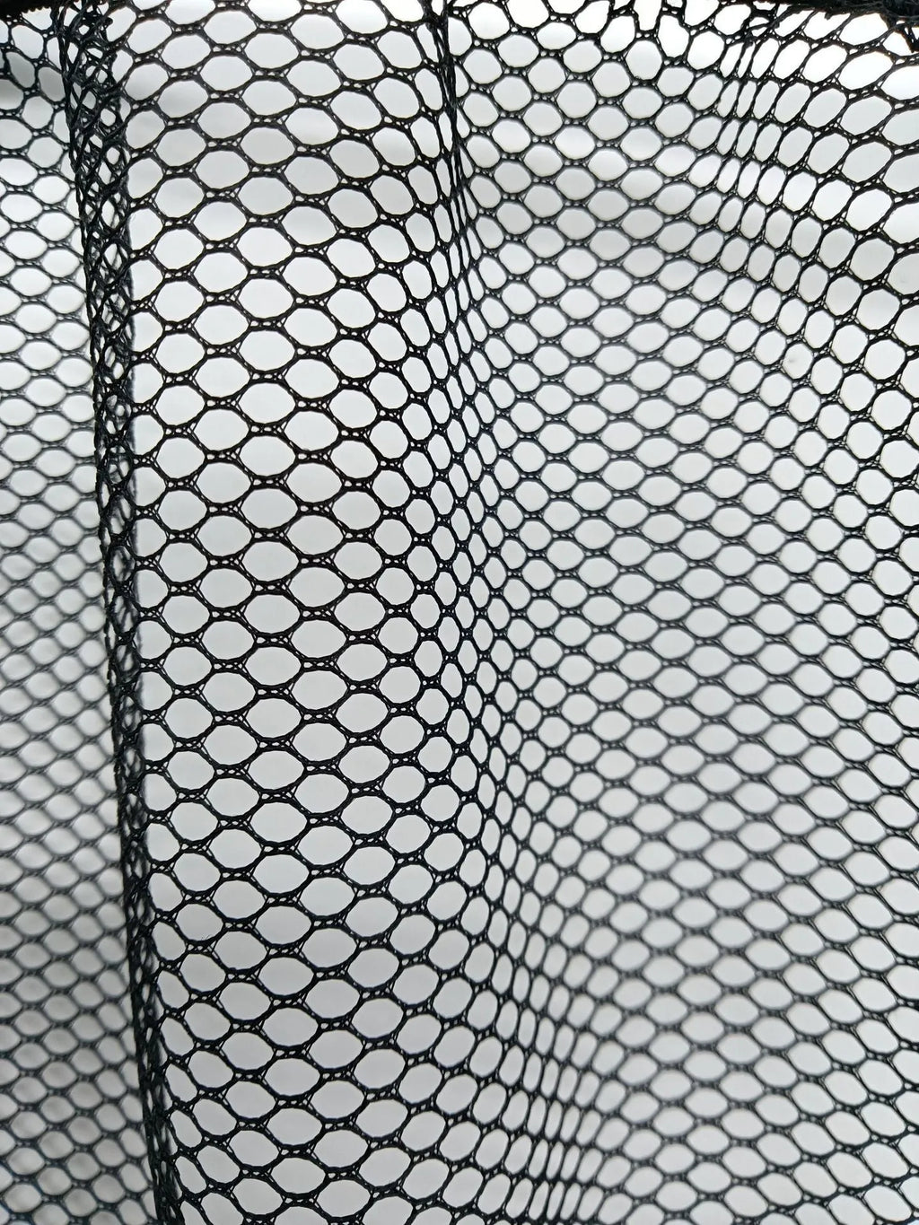 Elastic polyester mesh car boot storage organiser net shown in a vehicle trunk.