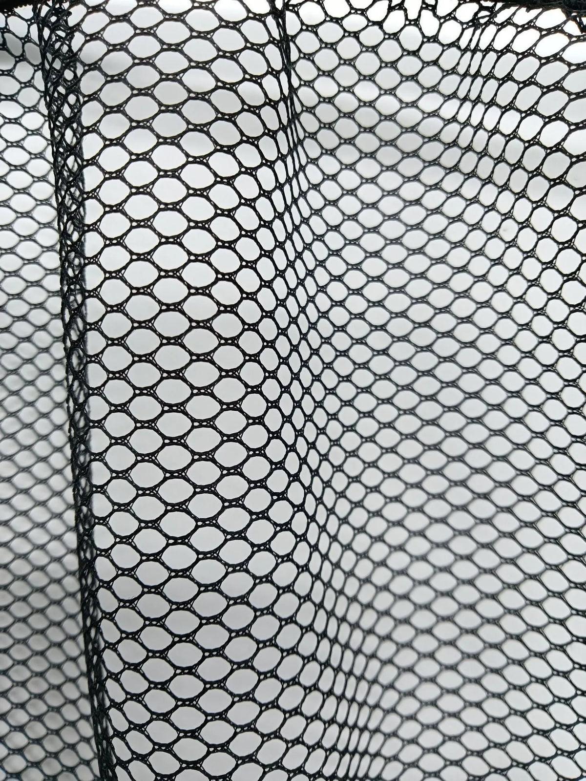 Elastic polyester mesh car boot storage organiser net shown in a vehicle trunk.