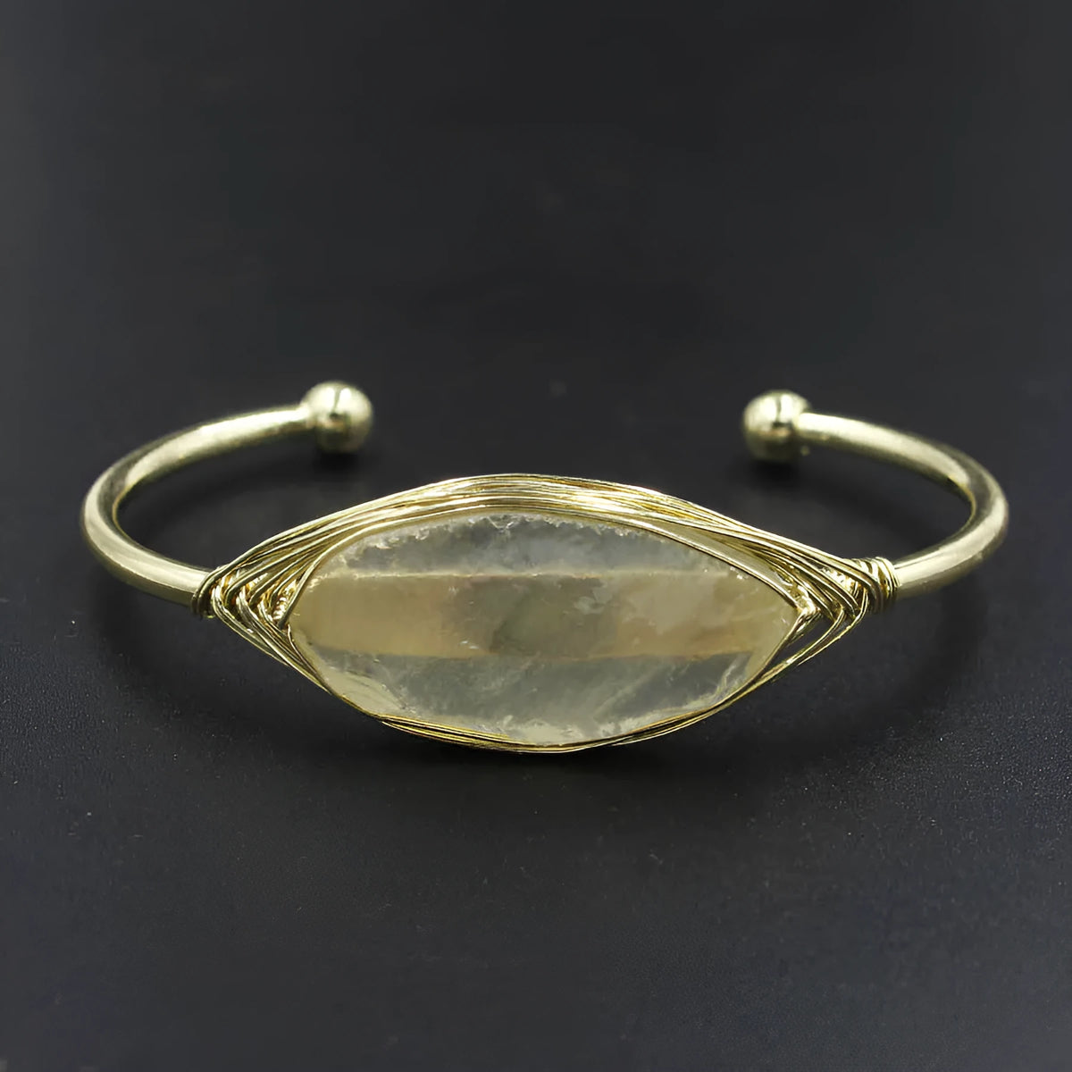 Natural raw gemstone bracelet in winding design on wrist, showing amorphous crystal stones and simple clasp.