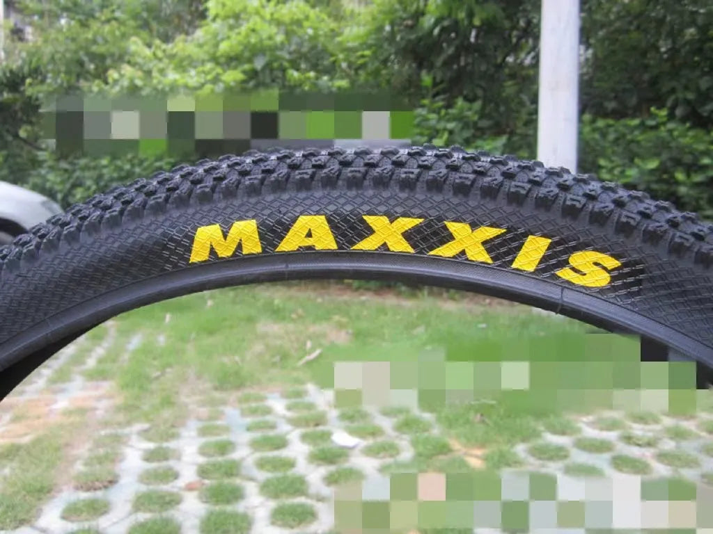 Ultralight black mountain bike tyre with puncture proof tread, shown in 26, 27.5 and 29 inch sizes.