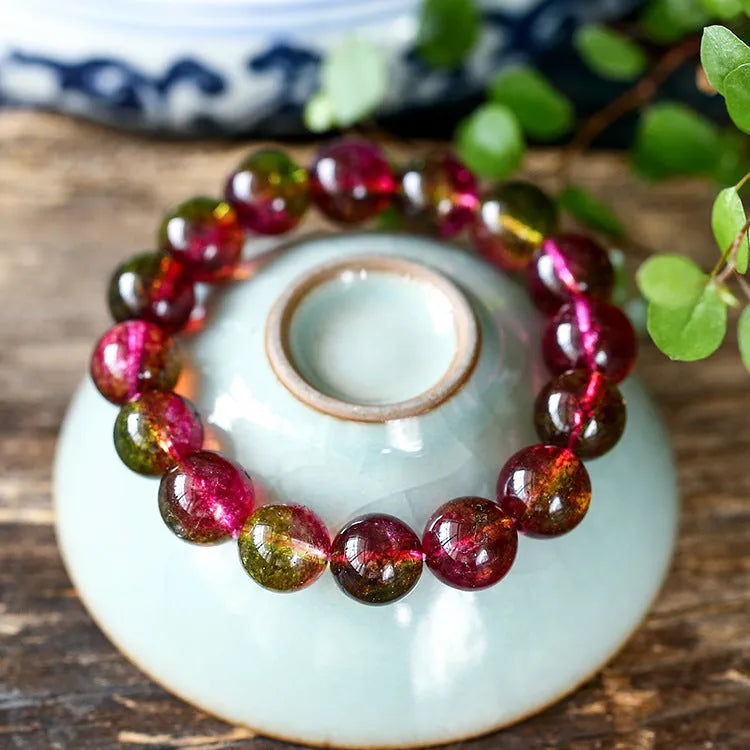 Women's handmade watermelon crystal bracelet on wrist, showing pastoral style and available bead sizes.