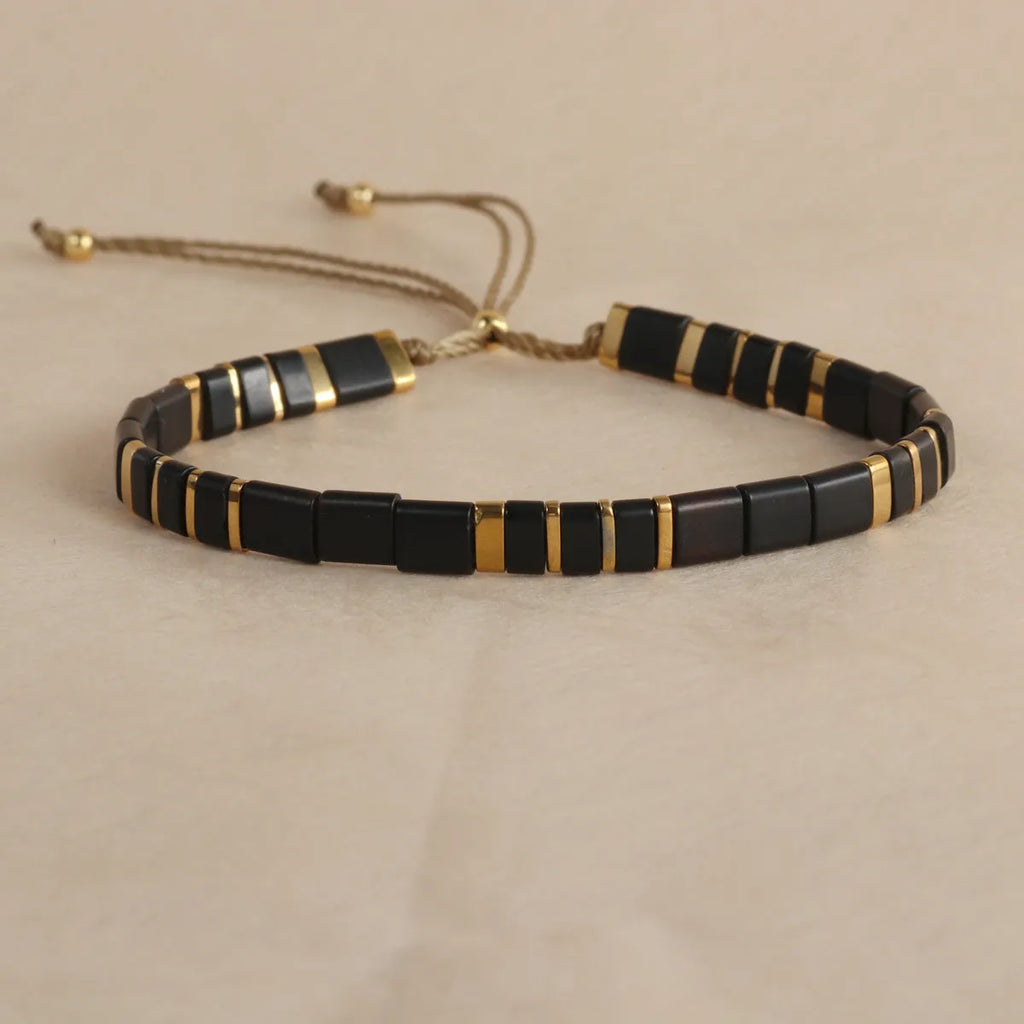 Glass bead geometric bracelet with round beads in five colour variations on wrist