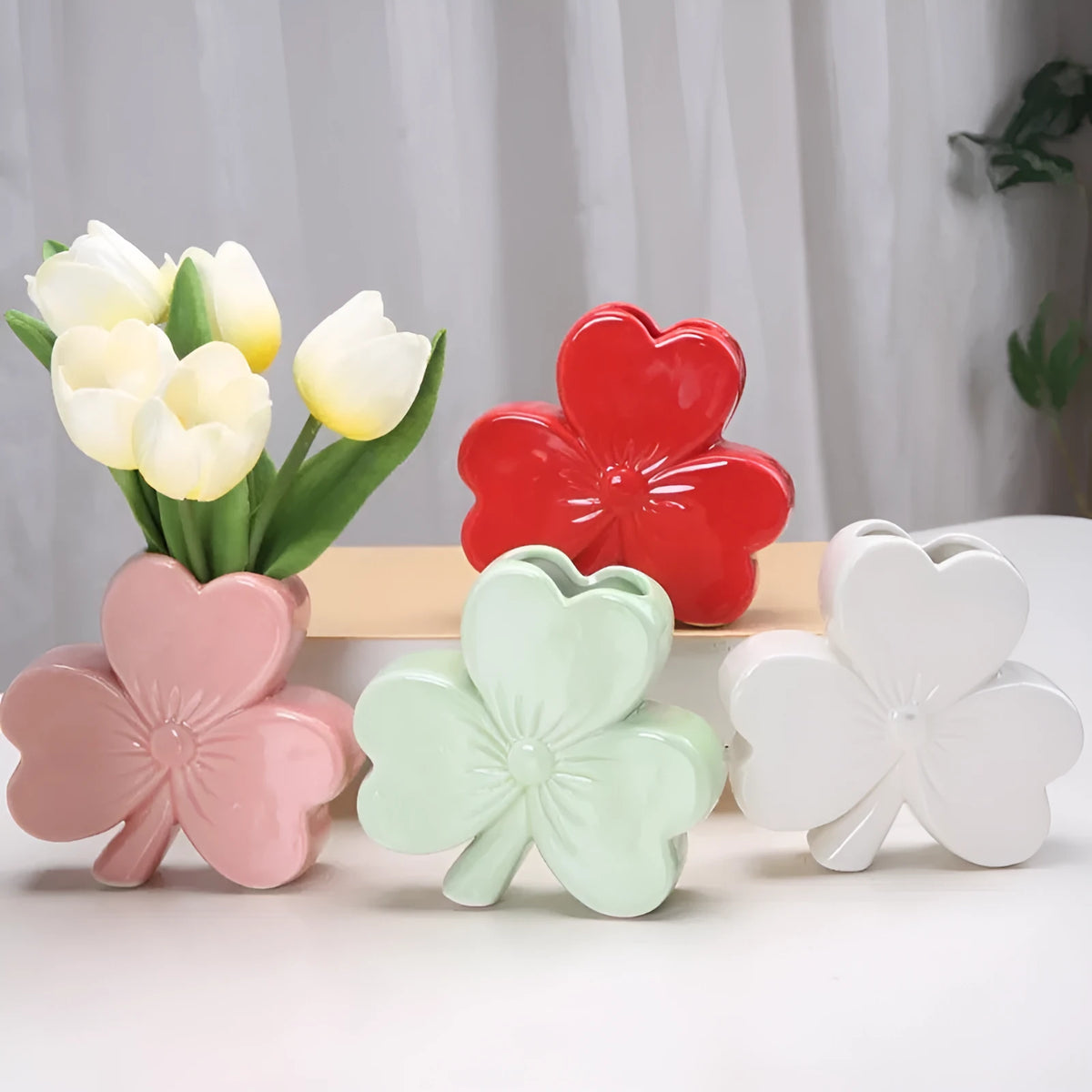 White porcelain clover-shaped ceramic vase in light green, pink, red, or white colours.