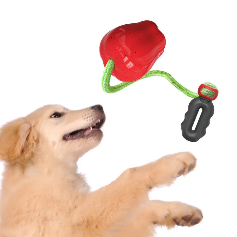 Green apple-shaped dog chew toy with treat dispensing opening and plastic construction