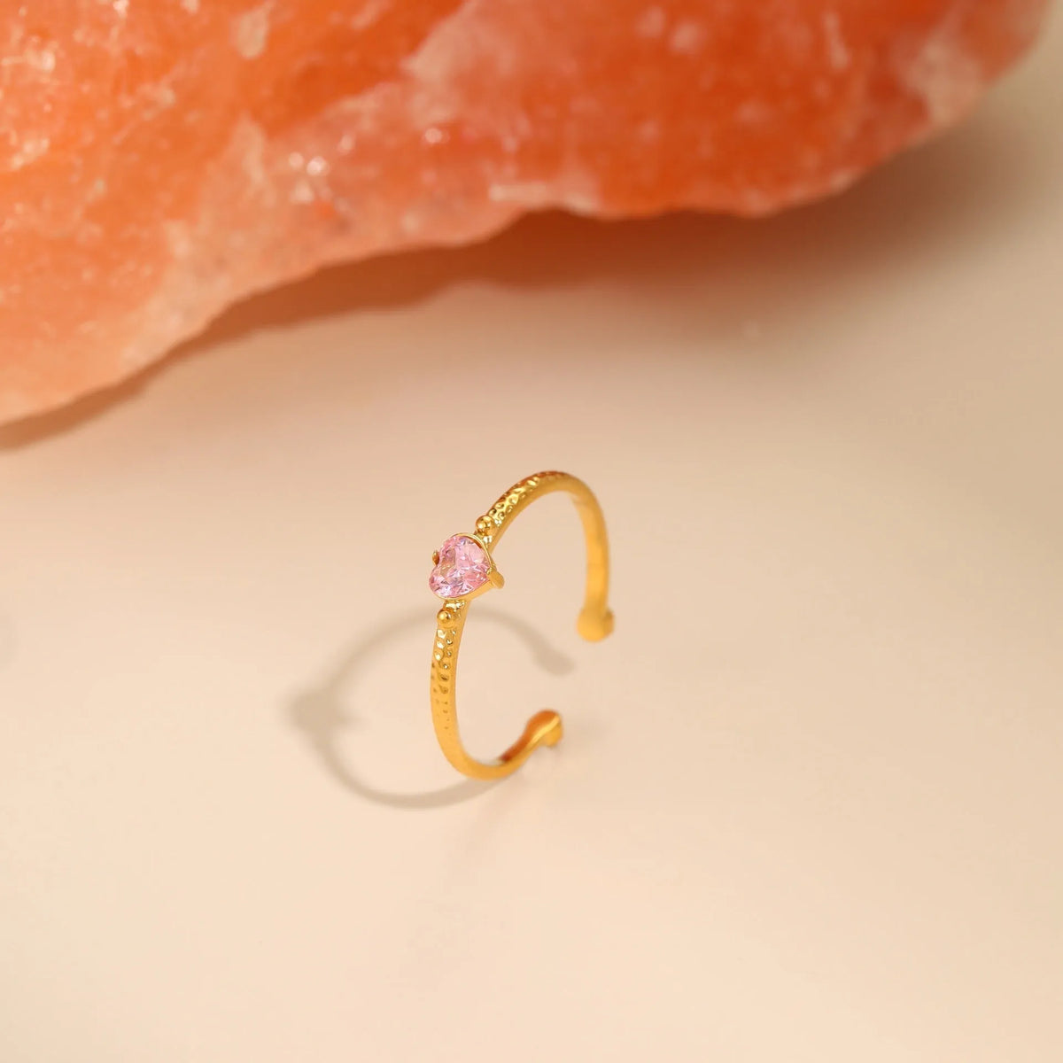 Open ended heart shaped ring with zircon accents in stainless steel showing geometric design details