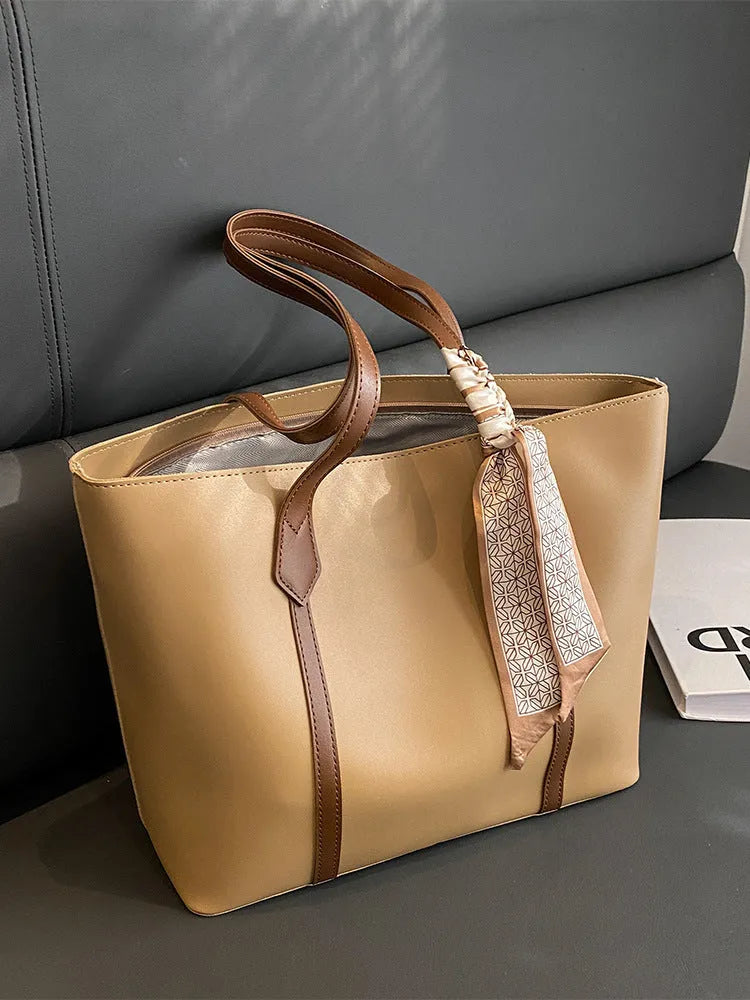 Women's soft bucket shoulder bag in various colours showing crossbody strap and zippered compartment