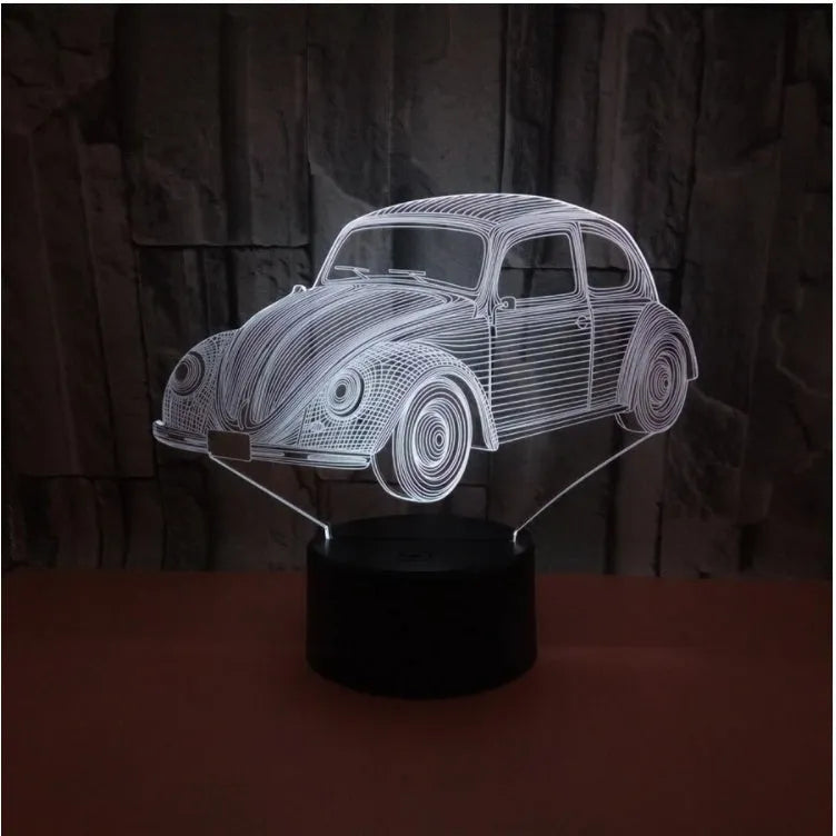 Modern black or crack finish 3D LED table lamp with touch controls and remote on a desk.