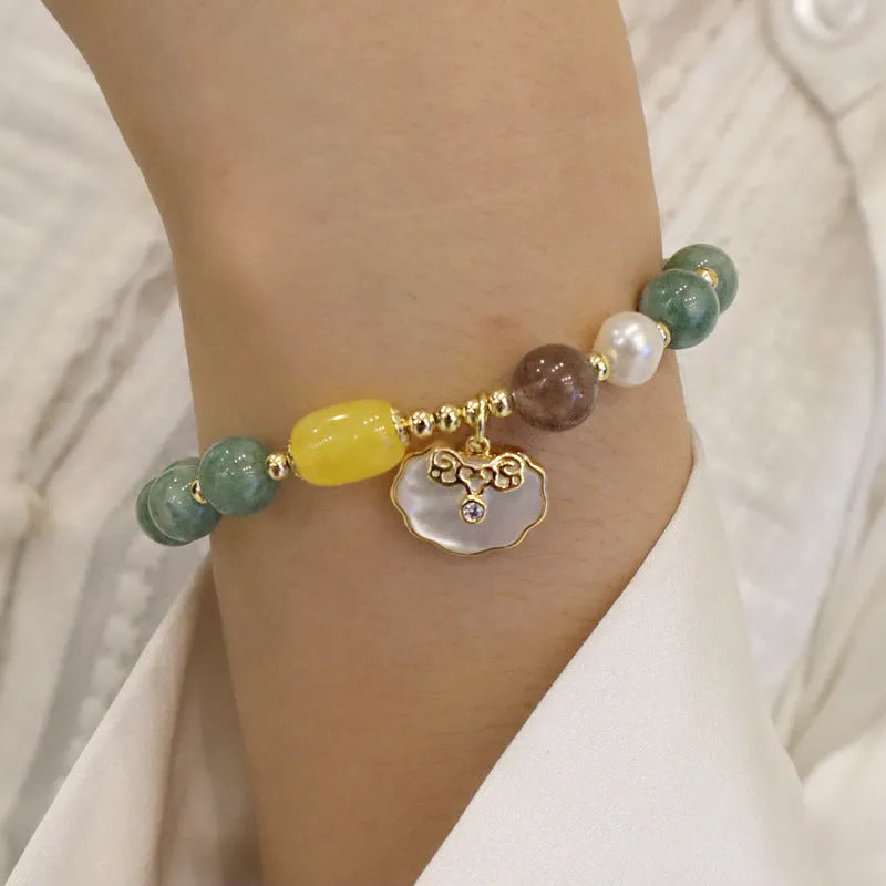 Green jade bracelet with shell pattern beads on an adjustable black cord.