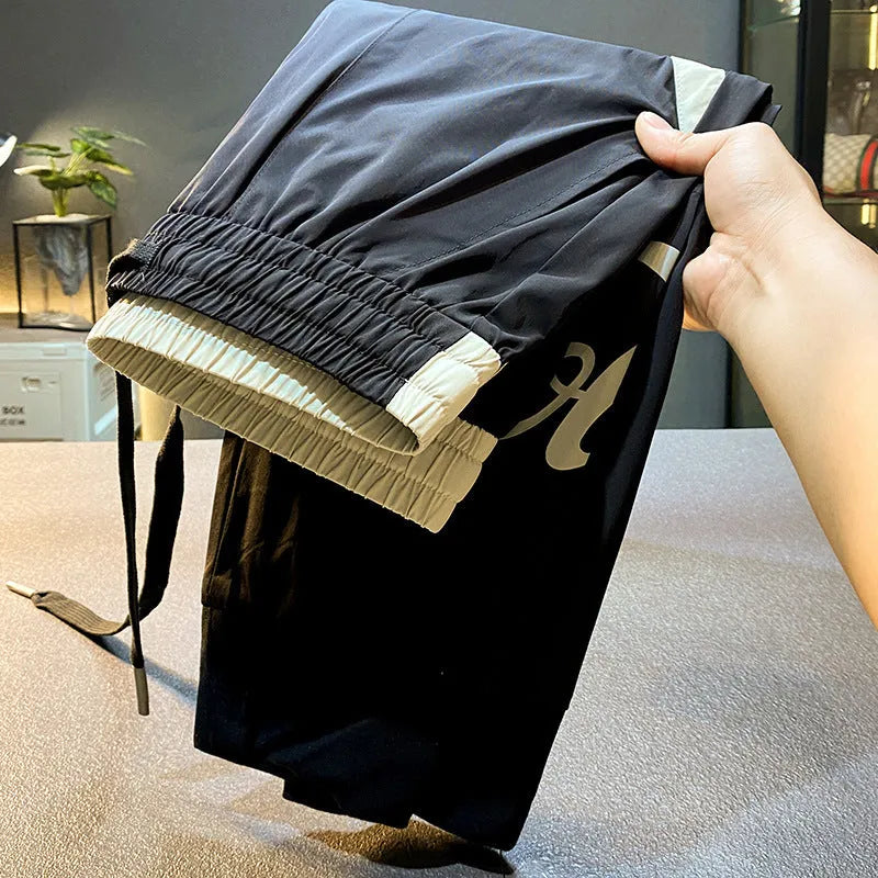 Black men's cropped casual trousers with ankle band, made from ultra-thin ice silk fabric.