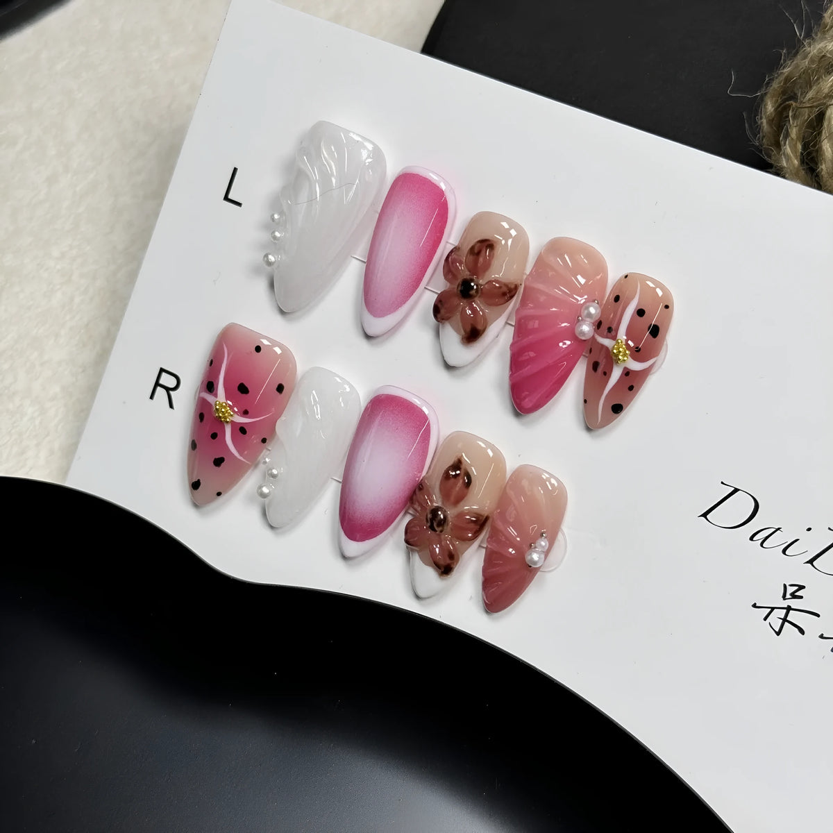 Close-up of hand-painted 3D nail patch with embossed candy pattern on an almond-shaped nail.