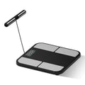 Black electronic body composition scale with tempered glass platform and colour display showing measurements
