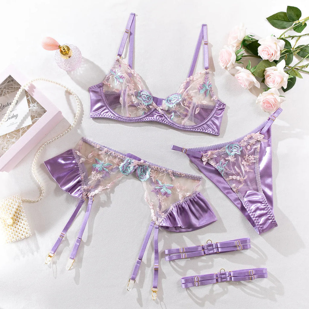 Light purple satin lingerie four-piece set with embroidery detailing on hanger